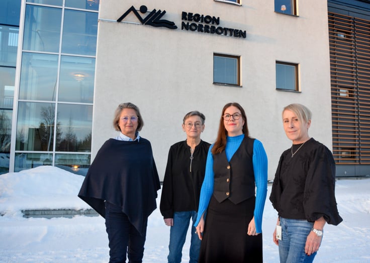 En grupp kvinnor som st&aring;r framf&ouml;r en byggnad.